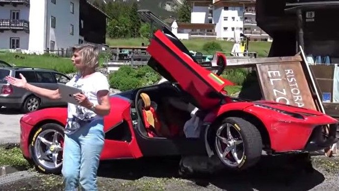 LaFerrari somehow winds up on a large rock in front of a restaurante