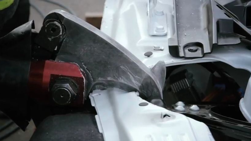 A hydraulic tool cuts apart the Tesla Model S