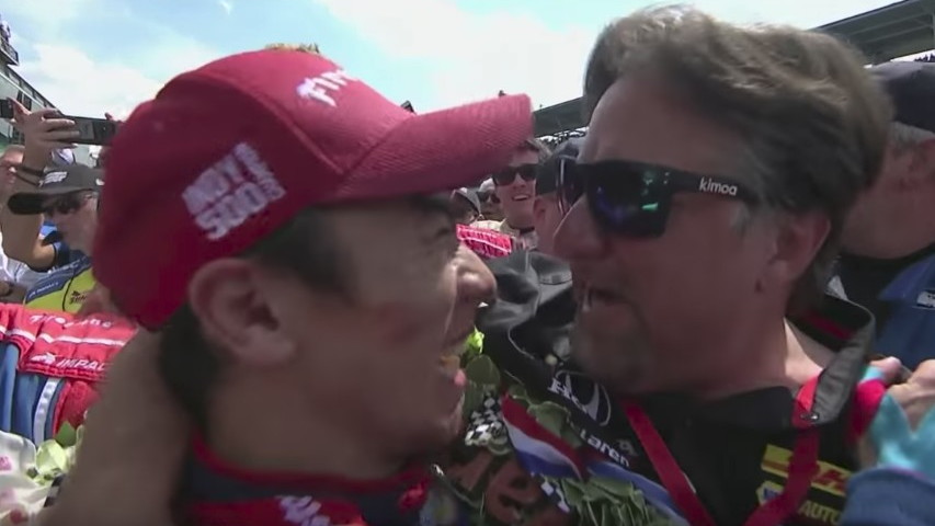 Takuma Sato and Michael Andretti embrace at the end of the Indy 500