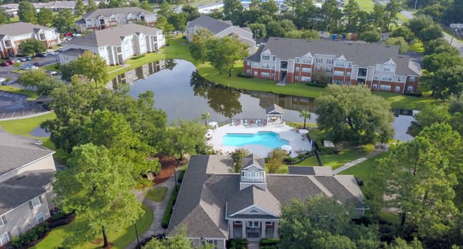 Savor the panoramic splendor of Eagle's Pointe in Brunswick, Georgia, from high above. An enchanting haven where the lake glistens, greenery flourishes, and a vibrant community thrives.