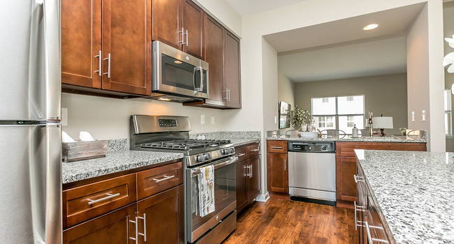 Beautiful, gourmet kitchens featuring granite, stainless steel appliances including gas range